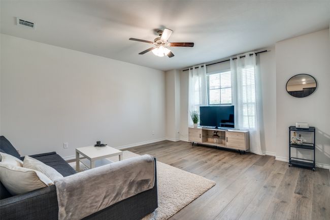 Living room with a ceiling fan and wood finished floors | Image 6