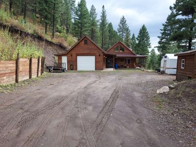 View of front of house featuring a garage and an outbuilding | Image 2