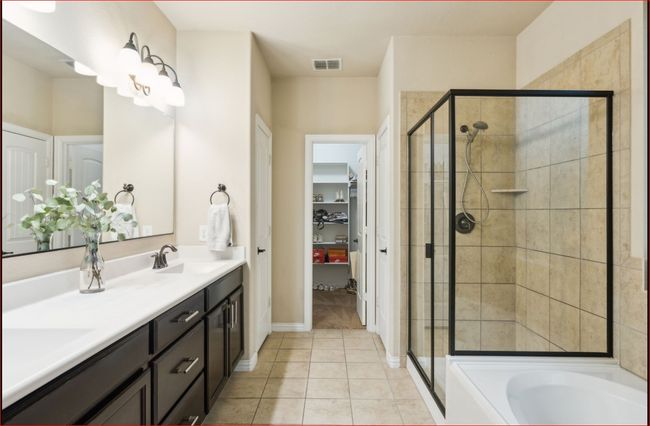 Bathroom featuring a stall shower, double vanity, tile patterned floors, a bath, and a spacious closet | Image 17