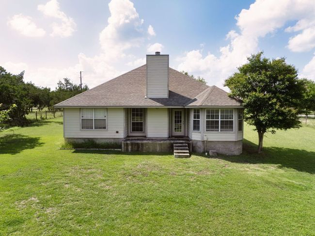 Back of property featuring a small concrete patio. | Image 19