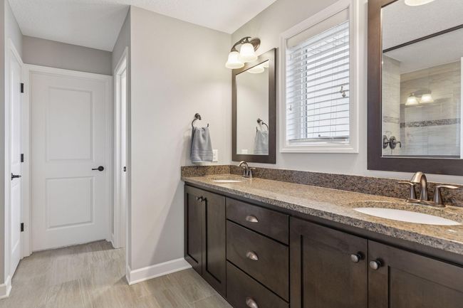 Dual vanity sink, access to walk-in closet and huge shower | Image 19