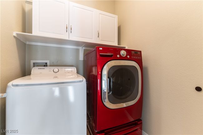 Laundry area featuring washer and clothes dryer and cabinet space | Image 21