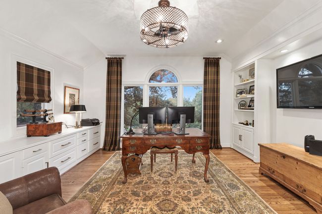1st Guest suite is great as an office with built-ins, hardwood floors and large windows overlooking front of home | Image 23
