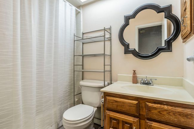 Full bath featuring vanity, toilet, and a shower with curtain | Image 22