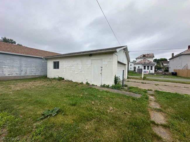 Back of house with a garage and a yard | Image 5