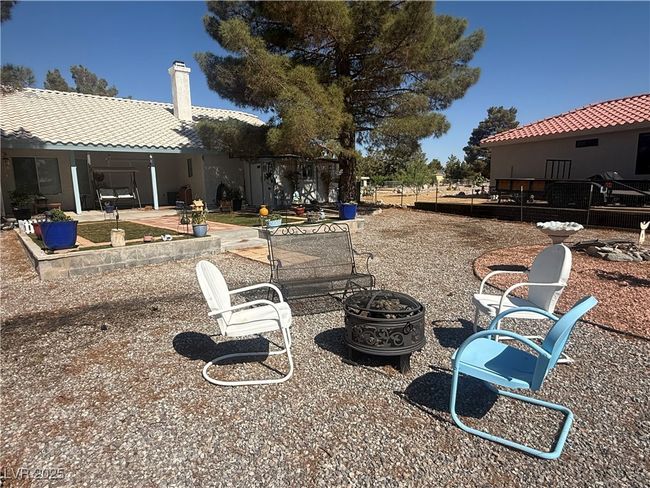 View of yard with a fire pit and a patio | Image 64