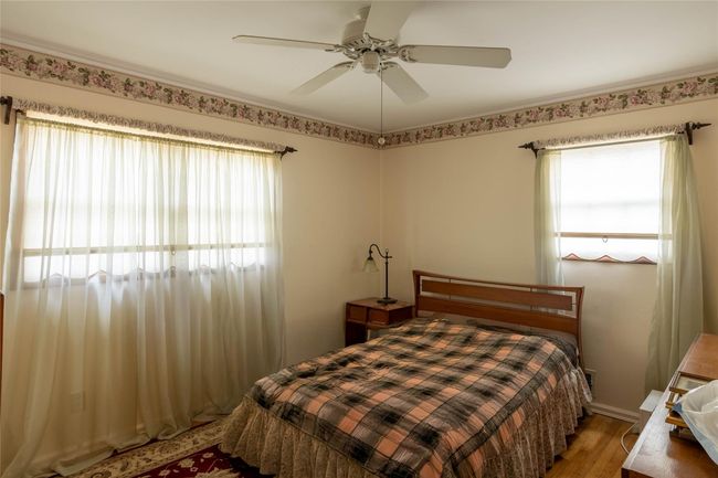 Bedroom featuring light wood-style floors and a ceiling fan | Image 13