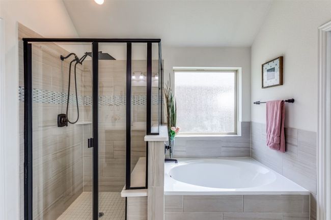 Full bath featuring a bath and a stall shower with rain shower head | Image 16