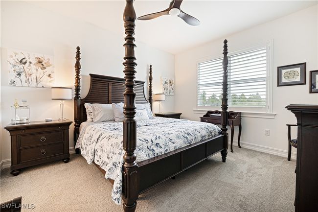 Bedroom with light carpet and ceiling fan | Image 18