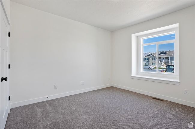 Unfurnished room with visible vents, baseboards, and carpet flooring | Image 15