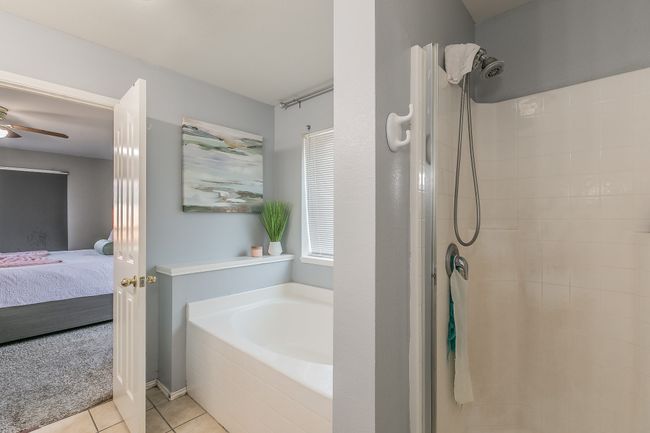 Ensuite bathroom with a bath, a tile shower, tile patterned floors, and ceiling fan | Image 23
