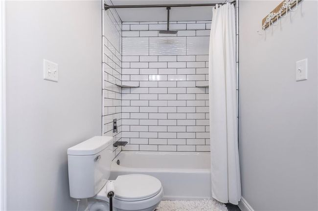 Bathroom with shower / bath combination with curtain and toilet | Image 19