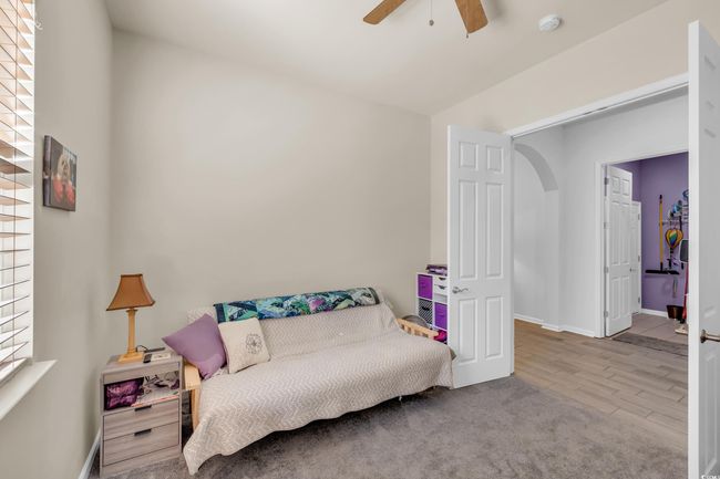 Living area with baseboards, wood finished floors, and a ceiling fan | Image 12