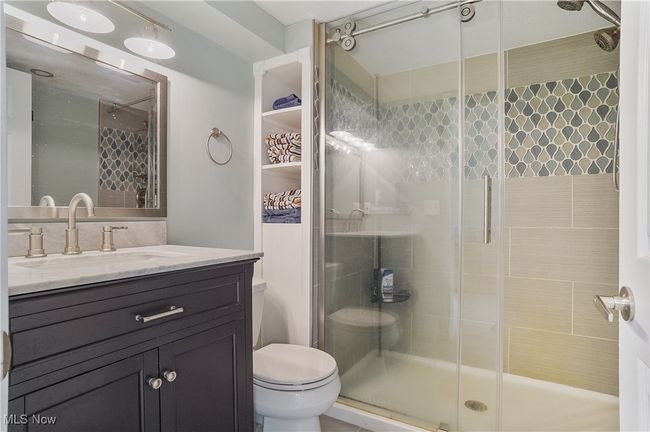 Full bath featuring a shower stall, toilet, and vanity | Image 39