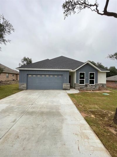 View of front of property with a front yard and a garage | Image 1