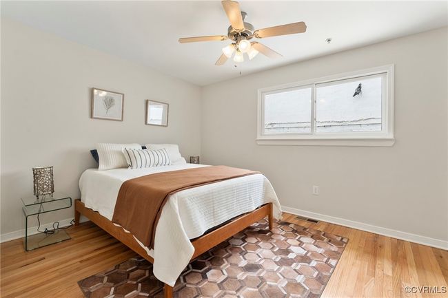 Bedroom with light wood-type flooring and ceiling fan | Image 14
