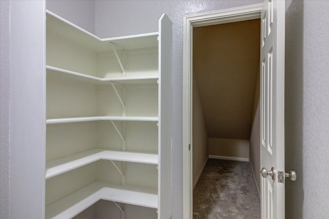 View of pantry and oversized storage space under the stairs! | Image 13