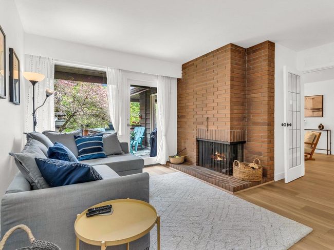 Living room featuring a fireplace and wood finished floors | Image 11