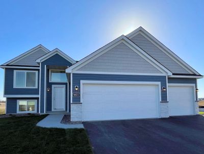 Open concept living featuring a vaulted ceiling in the kitchen, dining, and great room. Virtually staged photo of a different home with similar plan and finishes. Photo may not depict actual plan, materials, & finishes may vary. | Image 1