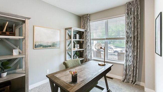 The main level office/flex room with french doors is loved by many! You even have a view of the fireplace from your workspace! | Image 20