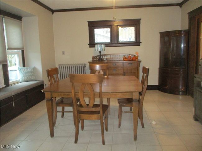 Tiled dining room featuring crown molding and radiator | Image 28