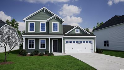 Craftsman-style home featuring a garage and a front lawn | Image 1