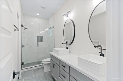 Bathroom featuring an enclosed shower, tile patterned floors, vanity, and toilet | Image 3