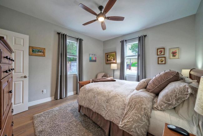 Bedroom featuring baseboards, wood finished floors, and a ceiling fan | Image 22