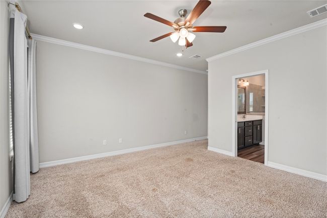 Unfurnished bedroom featuring carpet flooring, ornamental molding, baseboards, recessed lighting, and ensuite bath | Image 16