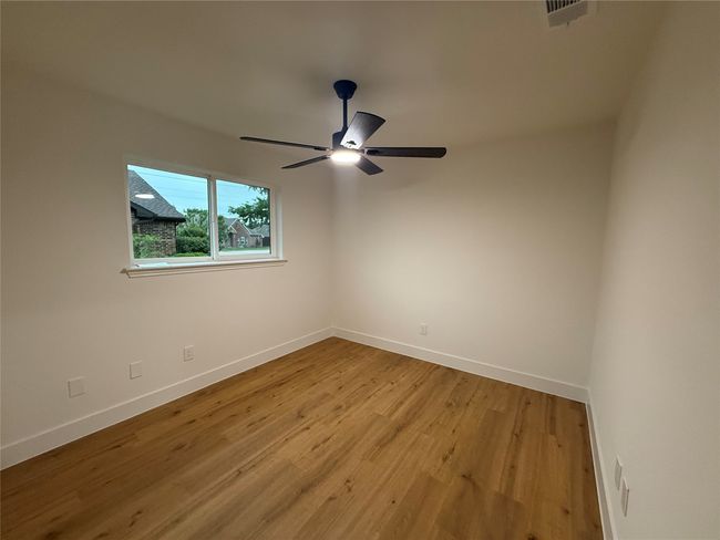 Secondary bedroon with walk in closets and ceiling fans | Image 16