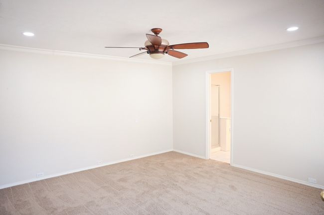 Spare room featuring ceiling fan, ornamental molding, recessed lighting, and light colored carpet | Image 35