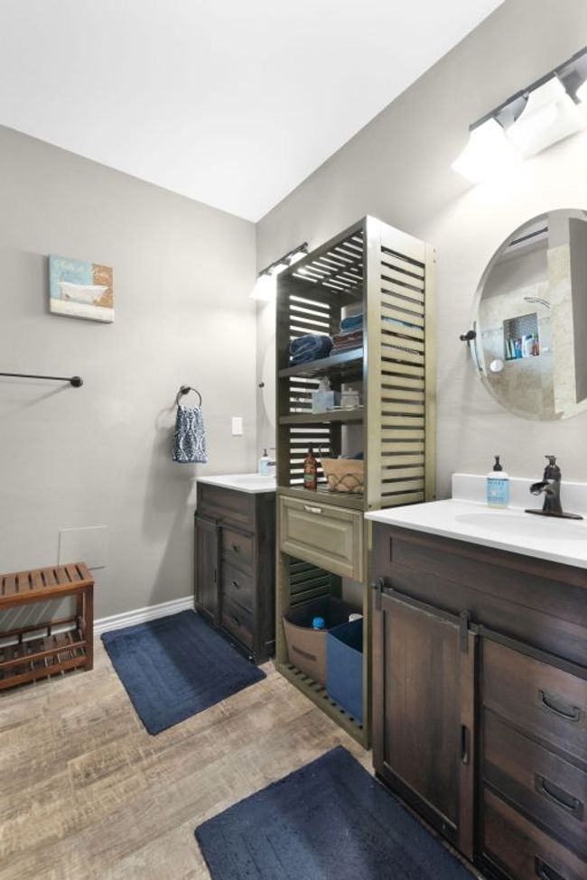 Full bath with two vanities, baseboards, and a sink | Image 19