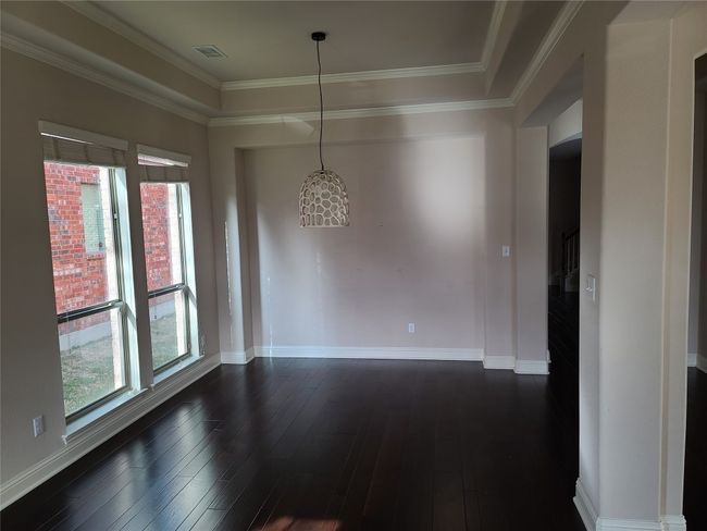 Unfurnished room with dark wood-style flooring and ornamental molding | Image 6