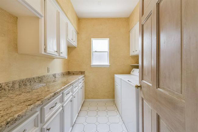 Larger-than-most Utility Room includes extra storage and work space galore | Image 20