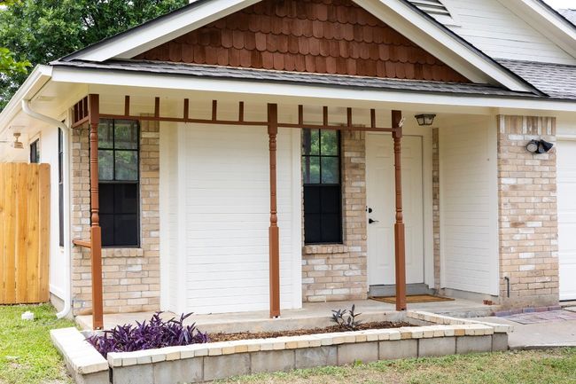 View of front of home with covered porch and brick siding | Image 5