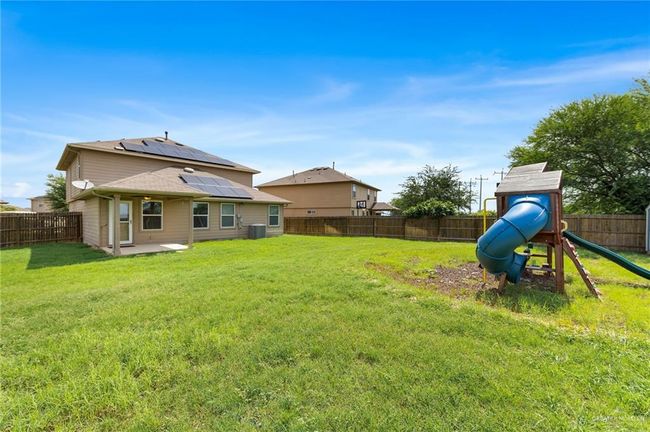 Fenced backyard with a patio and a playground | Image 30