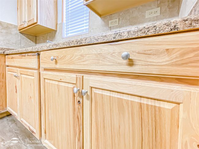 Detailed view of light brown cabinets, light countertops, and light wood-type flooring | Image 18