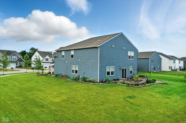 view of side of property featuring a residential view and a yard | Image 38