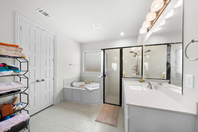 Full bath with vanity, a bath, a shower stall, and tile patterned floors | Image 14