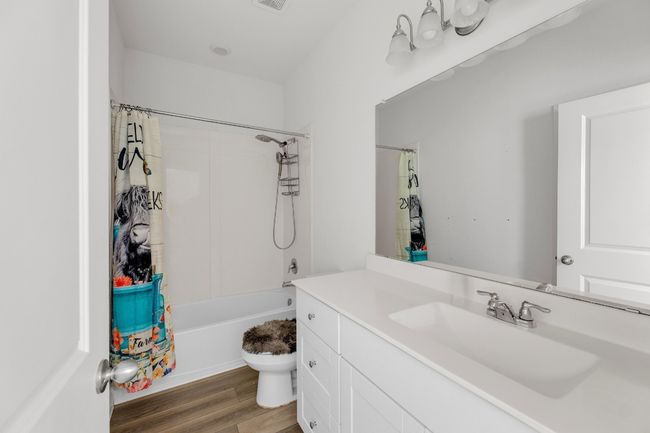 The primary bathroom features modern finishes and a clean, functional layout. | Image 16
