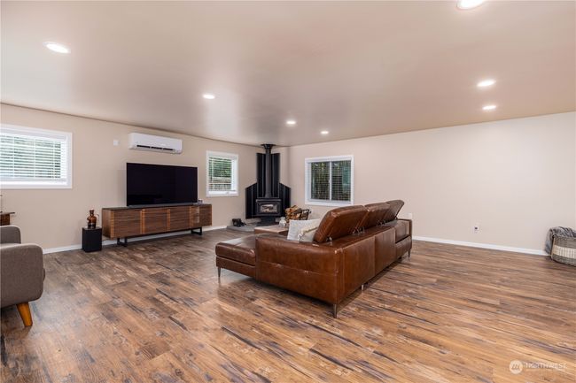 Another angle of the family room with AC and wood stove. On main level | Image 13