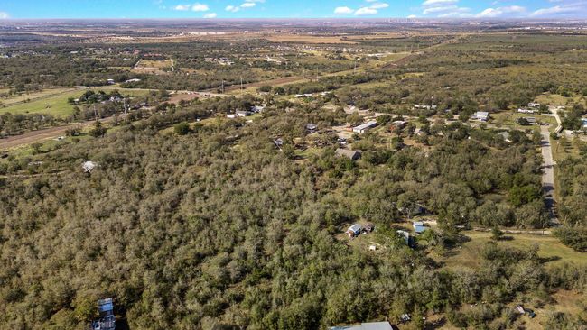 Aerial view of property and surrounding area featuring a heavily wooded area | Image 33