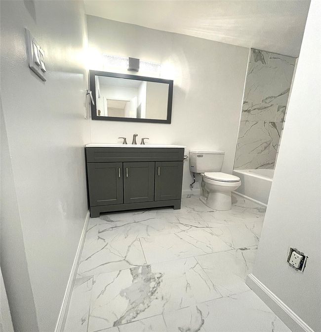 Full bathroom featuring toilet, marble finish floor, vanity, and baseboards | Image 16