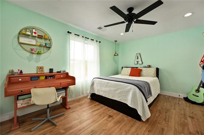 Secondary bedroom with LVP flooring and ceiling fan | Image 40