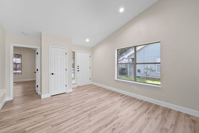 Entryway with light wood finished floors, healthy amount of natural light, vaulted ceiling, and recessed lighting | Image 6