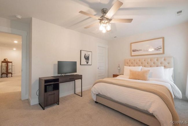 Bedroom featuring light colored carpet and ceiling fan | Image 43