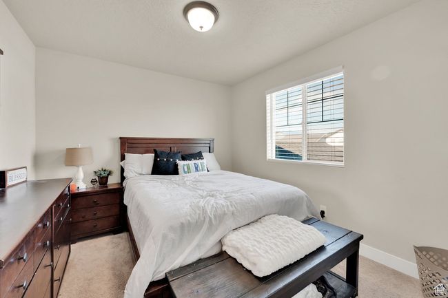 Bedroom with light carpet and baseboards | Image 25
