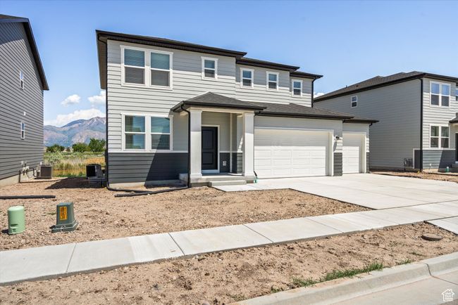 Prairie-style home featuring driveway, a mountain view, and a garage | Image 6