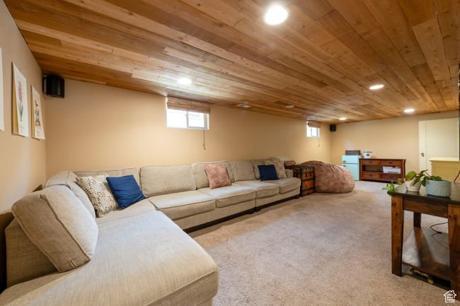 Carpeted living room featuring wooden ceiling and recessed lighting | Image 18