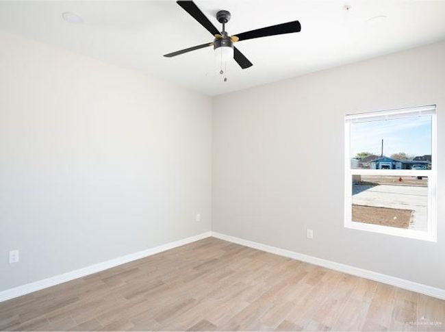Empty room featuring ceiling fan and light hardwood / wood-style floors | Image 8